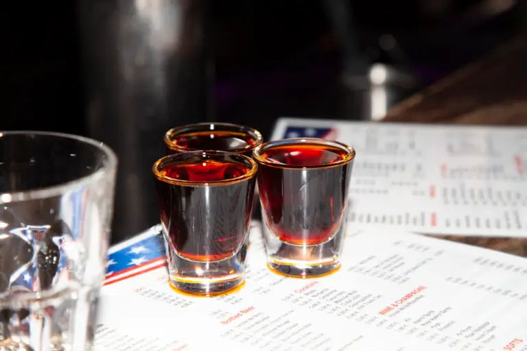 Three Jagerbombs over a menu on a bar counter